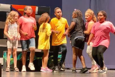 Children rehearsing onstage 